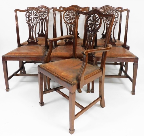 A set of seven George III style mahogany dining chairs, each with fan design to the pierced back, with drop in leather seats, on square tapering legs and spade feet.