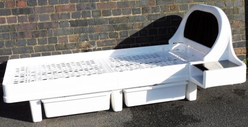 A James Seccombe space age single bed, in moulded plastic with an integrated side table, 65cm high.