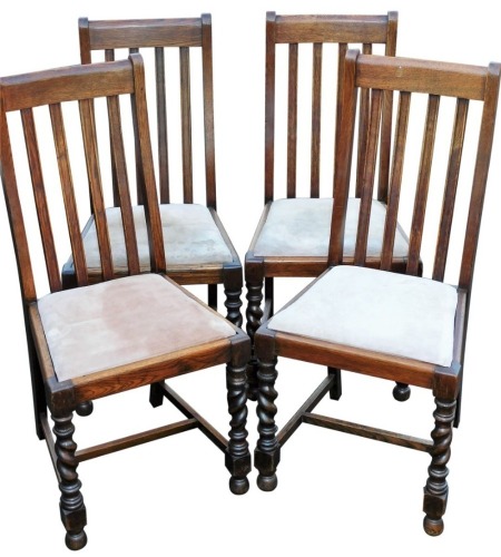 A set of four early 20thC oak dining chairs, with vertical back splats and barley twist front legs, terminating in ball&nbsp;feet, 101cm high. (4)