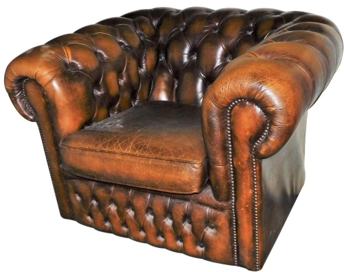 A 20thC brown leather Chesterfield chair, with button back and arms, and removable seat, 101cm wide.