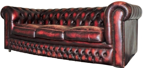 A 20thC red leather three seater Chesterfield settee, 178cm wide.