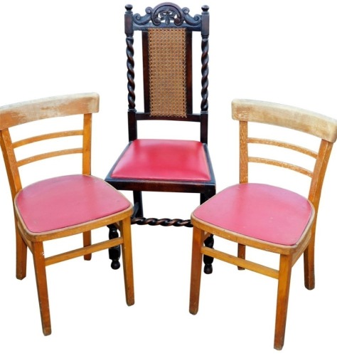 A Carolean style oak chair, with curved cresting rail and red leatherette drop in seat, with a cane back on barley twist front legs, 108cm high, and two further occasional chairs. (3)