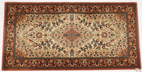 A Royal Khan Persian style rug, cream and red ground, decorated with a central medallion, flowers and leaf within a repeating floral border, 159cm x 82cm.