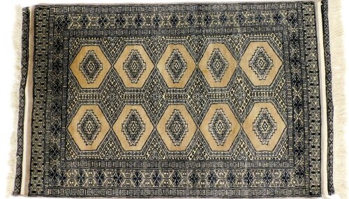 A Tekke mocha and black ground rug, decorated with two rows of five guls, within a repeating geometric border, 124cm x 79cm.