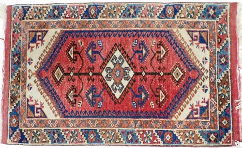 A Shiraz red ground prayer rug, decorated with a central medallion, tree of life, within repeating floral borders, 116cm x 76cm.