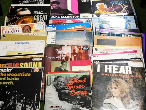 A collection of swing and jazz LP records, artists to include Louis Armstrong, George Lewis, Dave Brubeck, Ella Fitzgerald, Duke Ellington, etc.