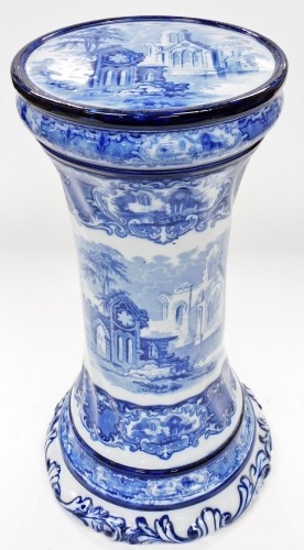 An early 20thC blue and white plant stand or pedestal, printed with the Abbey pattern, 53cm high.