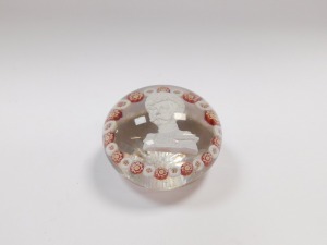 A 19thC Continental sulphide and millefiori glass paperweight, decorated with the bust portrait of a Russian Emperor, possibly Nicholas I, within alternating red and white millefioris, on a star cut base, 7cm diameter. (AF) - 4