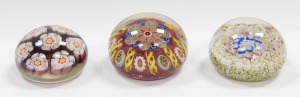 A millefiori and banded latticino glass paperweight, 8cm diameter, paperweight with seven large millefiori floral canes, 7cm diameter, and a concentric millefiori paperweight, with a pale green and silver ground, 7.5cm diameter. (3) - 3