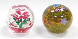 A Selkirk faceted glass paperweight, enclosing a single five petal pink flower and air bubbles, etched mark, dated 1997, 7cm diameter, and a further Selkirk butterfly paperweight, decorated with a butterfly and flowers, against a mottled moss ground, etch - 3