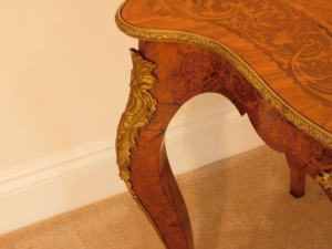 A 19thC kingwood walnut and rosewood marquetry topped serpentine centre table, with gilt metal mounts, 74cm high, 121cm wide, 76cm deep. - 3
