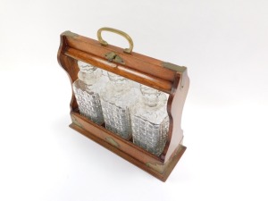 A 19thC oak tantalus, the oak case fitted with three cut glass decanters, and brass cap ends and swing handle support, with key, 35cm high, 34cm wide, 11cm deep. - 2
