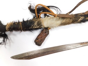 A Borneo Dayak Mandau, with a carved wooden bi-form handle set with animal hair, copper and wire bound, the blade of curved, plain form, in a bamboo sheath with carved and bound detailing, set to the rear pouch with animal's hair, enclosing a Langgei Puai - 3