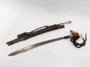 A Borneo Dayak Mandau, with a carved Aso head bone handle set with animal hair, metal and wire bound, the blade of curved, pierced and engraved form, in a wooden sheath with carved decoration and metal binding, set to the rear with a leather pouch, lackin - 2