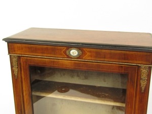 A Victorian walnut pier cabinet, the ebonised edged top over a glazed door, enclosing two shelves, raised on a plinth base and turned ebonies feet, 107cm high, 76cm wide, 30cm deep. - 2