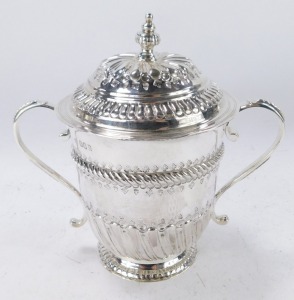 A George V Britannia silver copy of a seventeenth century porringer, of twin handled, covered form, with fluted and engraved decoration, oval vacant reserve, engraved No 131, Harry Freeman, London 1913, 12&frac12;oz, 17cm high. - 2