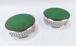 A pair of silver wine coasters, with a rounded wooden base and pierced fret border, Birmingham 1986, 9cm diameter, 3&frac12;oz all in. - 2