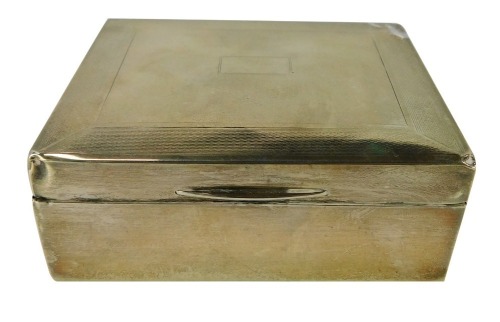 A George V silver cigarette box, with engine turned decoration and vacant shield, Birmingham 1932, 7&frac12;oz gross.