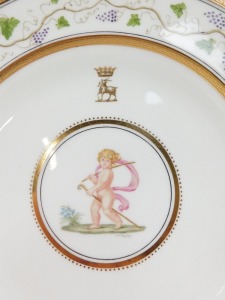 A pair of late 19thC Wedgwood porcelain plates, painted by J Thorley, with cherubs, one holding a staff and crosier, the other a ring, beneath a gilt crest of a goat beneath a coronet, believed to be Duke of Bedford crest, within a repeating vine border, - 3
