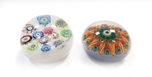 A Perthshire 1973 dated millefiori and scrambled cane paperweight, decorated with silhouette motifs, 7cm diameter, together with a millefiori and tubular cane paperwork, 6.5cm diameter. (2, AF)