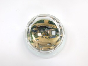 A 19thC faceted cut glass paperweight, decorated internally with a painted three dimensional scene of figures in a town, on opaline circular base, 9cm diameter. - 2