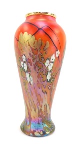 An Okra limited edition glass vase, designed by Dave Barras, of baluster form, decorated with trees, having gilt foliage and white blossom, against a red ground, etched marks, 21cm high.