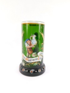 A late 19thC German green glass tankard, enamel decorated with an elfin figure holding a stein above a banner with hops and barley, reading "Dein Wohl Mein Liebchen" above a floral decorated foot, 16.5cm high. - 2