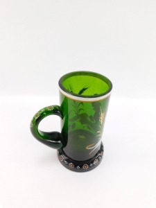 A late 19thC German green glass tankard, enamel decorated with an elfin figure holding a stein above a banner with hops and barley, reading "Dein Wohl Mein Liebchen" above a floral decorated foot, 16.5cm high. - 3