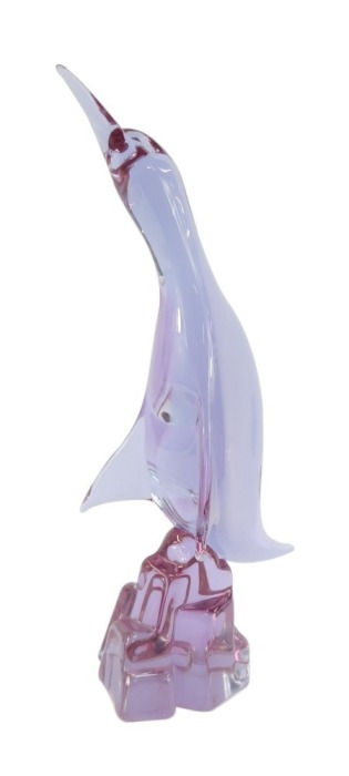 A Murano amethyst glass figure of a Cormorant, modelled perched on a rock, bears indistinct signature, 38.5cm high.