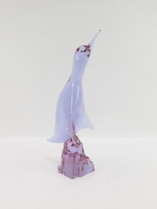 A Murano amethyst glass figure of a Cormorant, modelled perched on a rock, bears indistinct signature, 38.5cm high. - 2