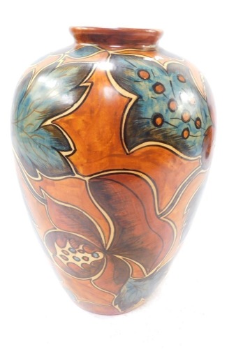 An early 20thC Clews Chameleon ware vase, decorated with stylised flowers against a light brown ground, No 234, impressed printed and painted marks, 25cm high.