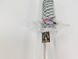 A Langham Glass paperweight, of dagger form, the handle with white and black spiral twist decoration, bears paper labels, 30cm wide. - 3