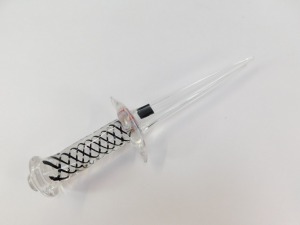 A Langham Glass paperweight, of dagger form, the handle with white and black spiral twist decoration, bears paper labels, 30cm wide. - 4