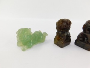 A pair of Chinese hard stone seals, modelled as Dogs of Fo, 93mm high, together with a pair of jadeite figures of recumbent children, 5cm wide. (4) - 2