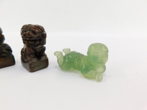 A pair of Chinese hard stone seals, modelled as Dogs of Fo, 93mm high, together with a pair of jadeite figures of recumbent children, 5cm wide. (4) - 3