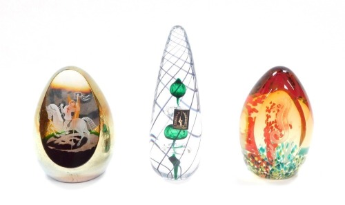A Langham Glass paperweight, of conical form, decorated with emerald green and clear stacked bubble inclusions, within spiral banding, bears paper label, etched mark, 14.5cm high, together with a Caithness St George and The Dragon paperweight, limited edi