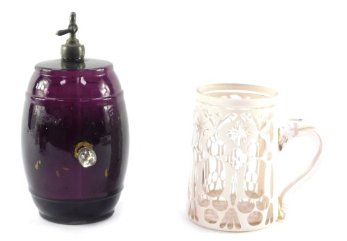 A Victorian milk glass cased tankard, with Gothic decoration, 13cm high, together with a 19thC amethyst glass barrel, with a clear glass stopper and metal tap with traces of gilt decoration, 15cm wide. (2)