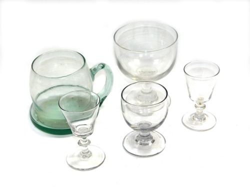 A Victorian glass rummer, raised on a waisted stem and conical foot, three further Victorian glasses and a green glass ale tankard. (5)