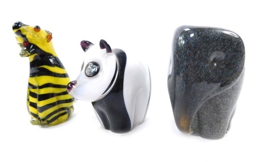 A Langham glass paperweight modelled as an elephant, 10cm high, a Wedgwood paperweight modelled as a panda, 9cm high, and a glass figure of a tiger, unmarked, 11cm high. (3)