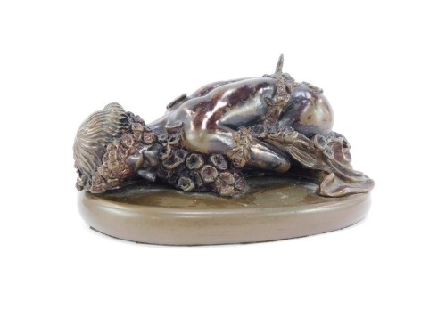 RT Pearce. A bronzed resin sculpture, of a reclining figure with flowers, raised on an oval base, 17cm wide.