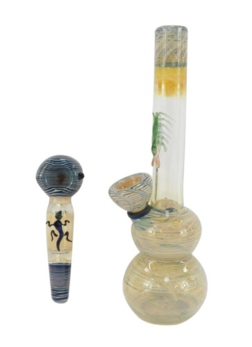 An opaline glass water and earth spoon pipe, moulded with a lizard, 12.5cm wide, together with an opalescent glass water pipe bung, moulded with a centipede, 22.5cm high. (2)