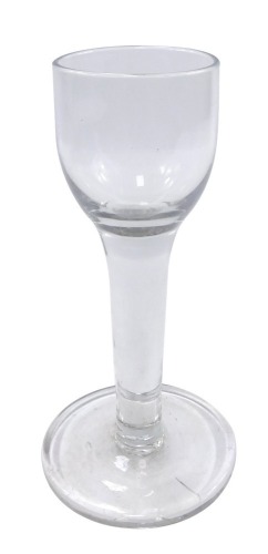 A Georgian style toasting glass, the bowl raised on a tapering plain stem and wide flattened foot, 18.5cm high.