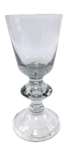 A Georgian style baluster wine glass, the bowl with air bubble inclusions to the base, raised on a knopped stem with air bubble inclusion, over a conical folded foot, 20cm high.