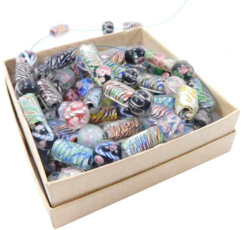 Venetian glass beads, floral and candy cane decorated, of ball or oblong form, some partially strung. (a quantity)