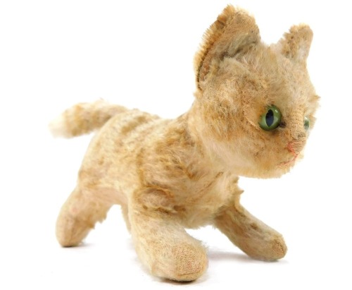 A Steiff vintage figure of a kitten, bears button to ear, 19cm wide.