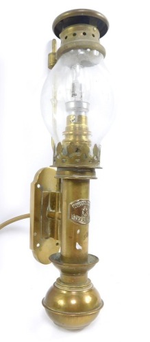 A White Star brass gimbal oil lamp, wall mounted, converted to electricity, 22.5cm high.