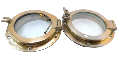 A pair of Simpson Lawrence of Glasgow brass portholes, one lacking fixing screw, 23cm diameter.