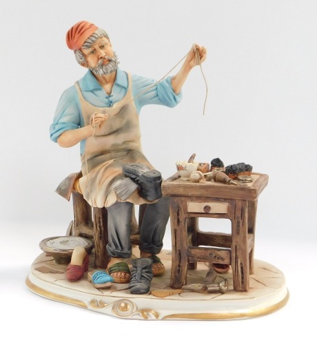 A Capo di Monte figure of a cobbler, with painted mark and paper label, 21cm high.