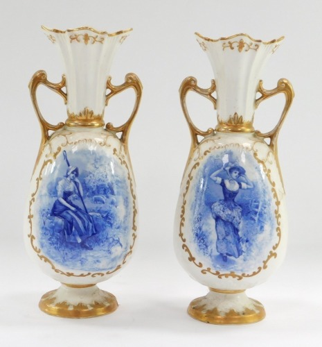 A pair of late 19thC Continental porcelain vases, of twin handled, baluster form, oval blue reserves decorated with a lady taking a stroll, a shepherdess and sheep, gilt heightened, 30cm high.