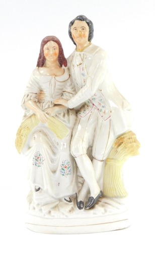 A Staffordshire flat back figure group, of a lady and gentleman with wheat sheaf, 34cm high.